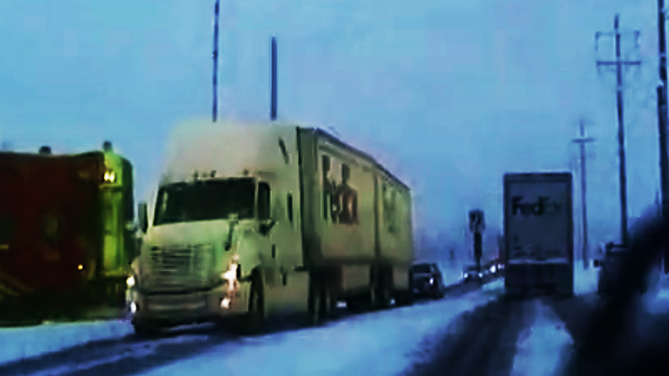 Watch what happens when this FedEx truck stops on the train tracks